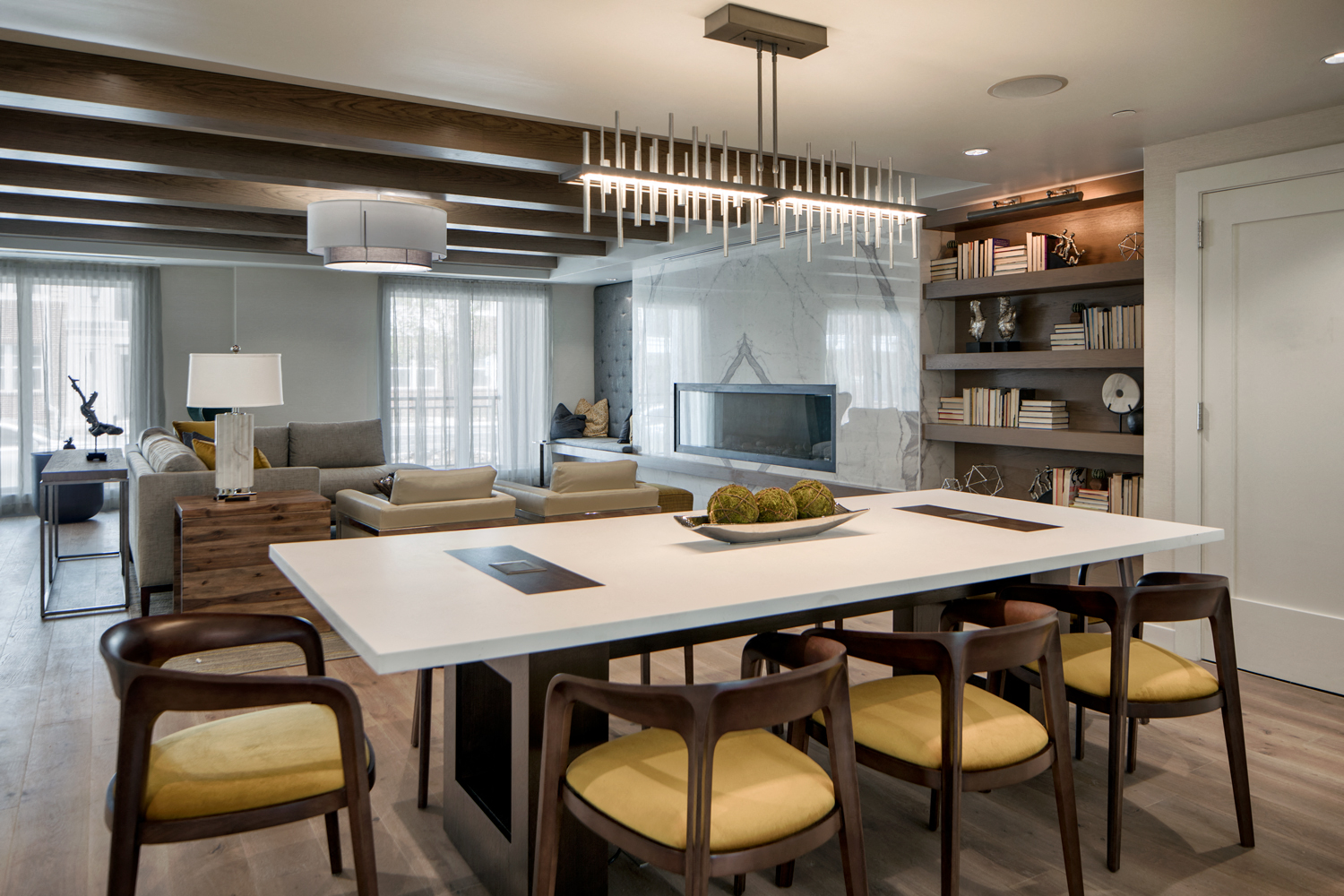 Community living room with plenty of comfortable seating, bar area for socializing, kitchen amenities, billiards table, and business area with available computers