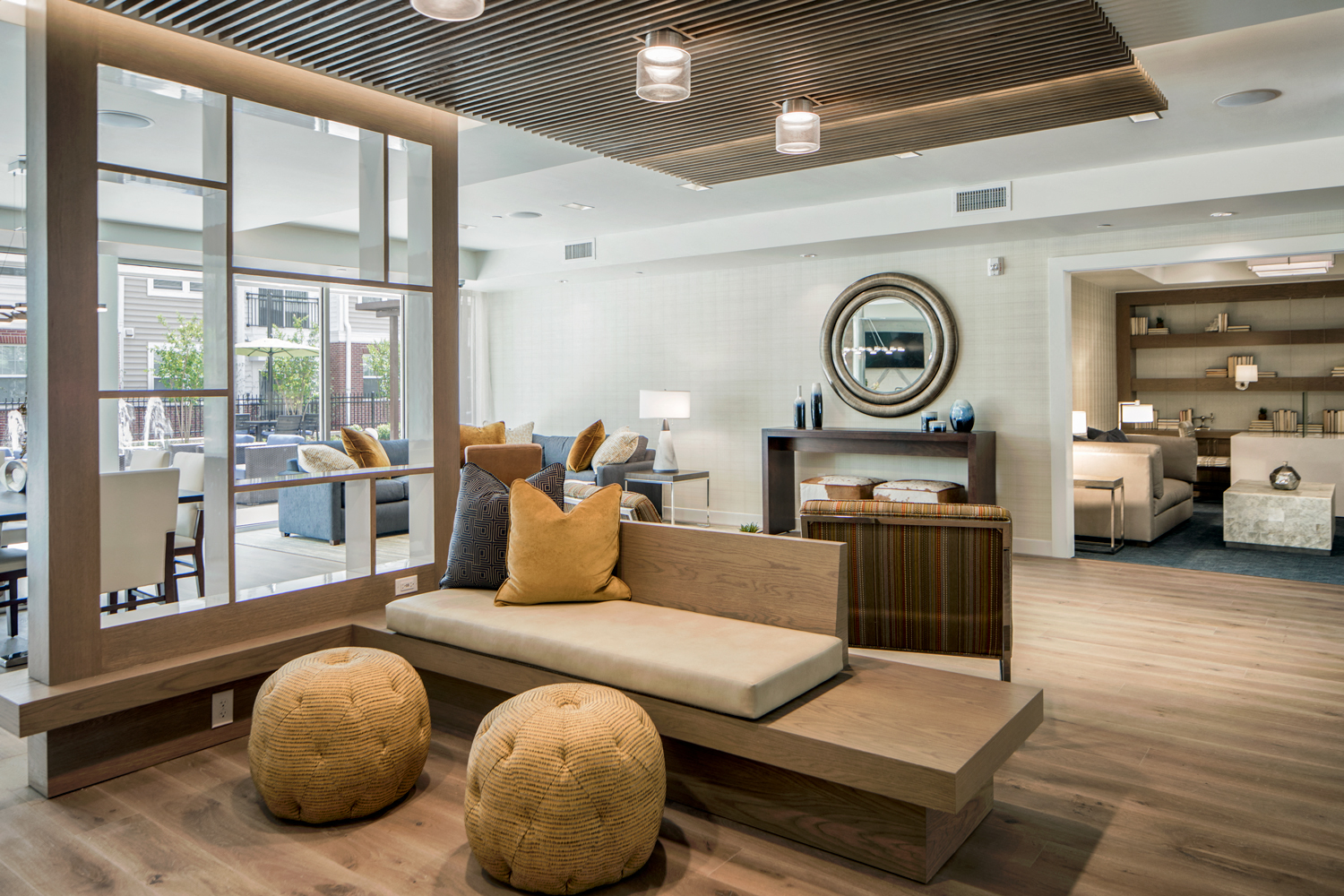 Community living room with plenty of comfortable seating, bar area for socializing, kitchen amenities, billiards table, and business area with available computers