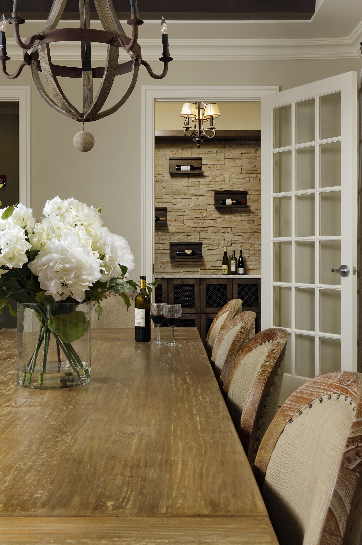 a dining room with a wooden table and chairs and a fireplace