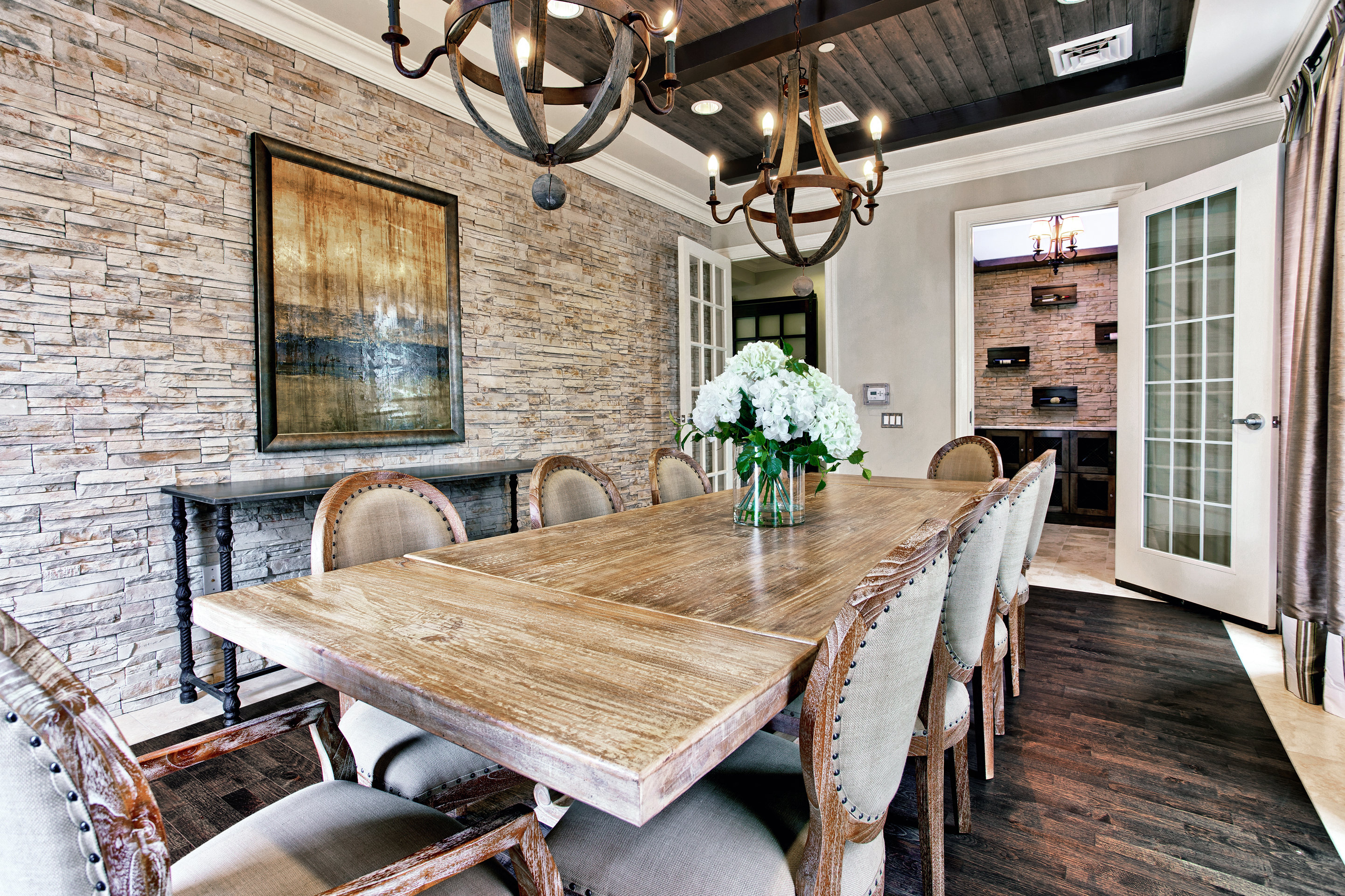 a dining room with a wooden table and chairs