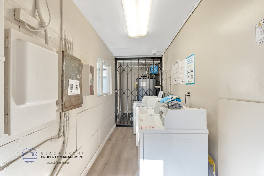 a laundry room with machines and papers on the wall