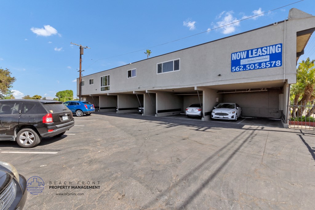 a parking lot with cars in front of a building