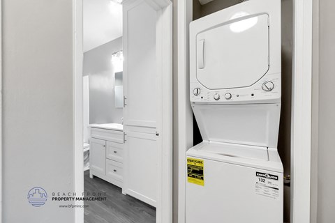 a white laundry room with a washer and dryer
