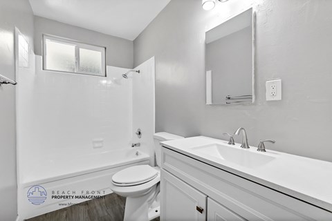 a white bathroom with a sink toilet and shower