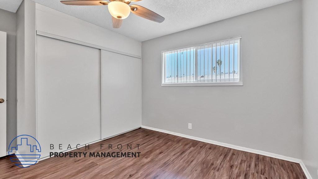 a living room with a ceiling fan and a window