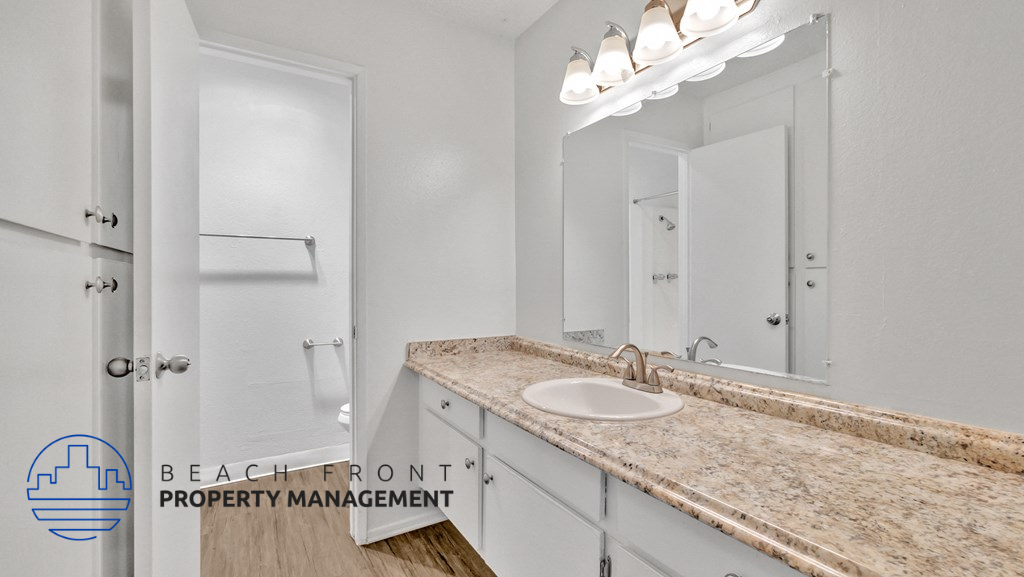 a bathroom with a sink and a mirror and a shower