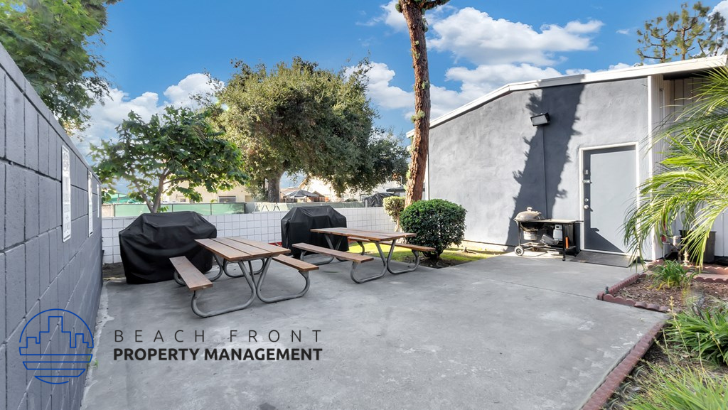 a patio with a table and chairs outside of a building