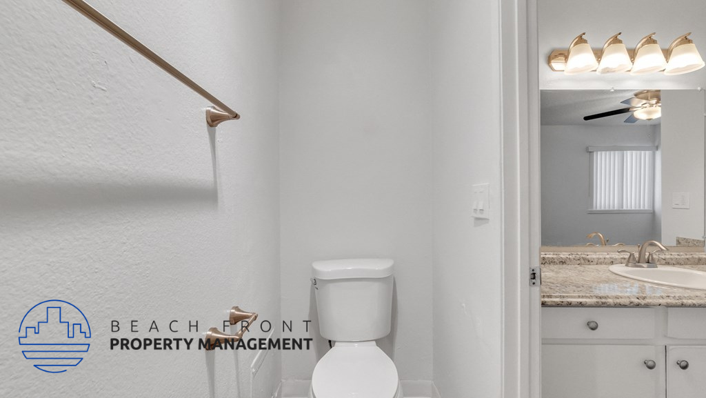 a bathroom with a toilet and a sink and a mirror