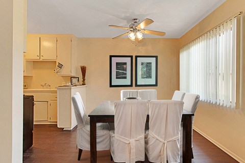 A dining room with a table set for two.