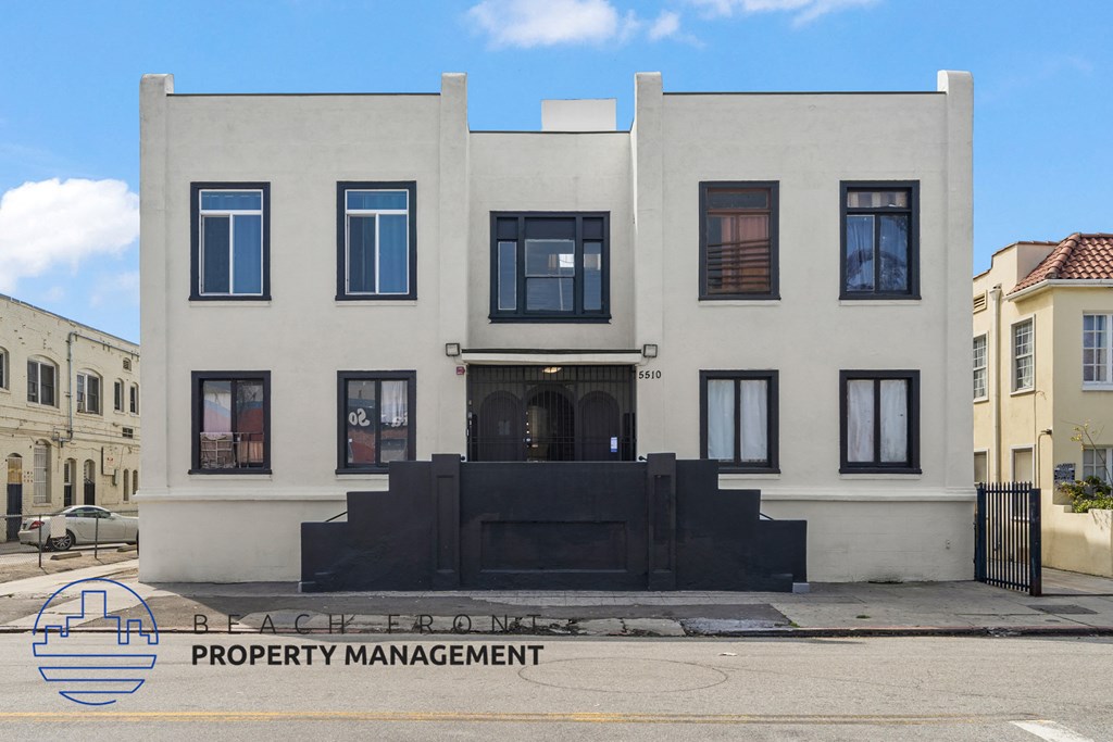 the front of a white building on a city street