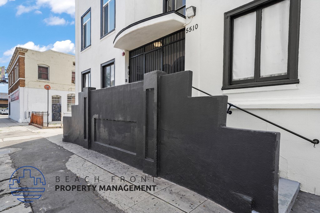 a black fence is in front of a white building