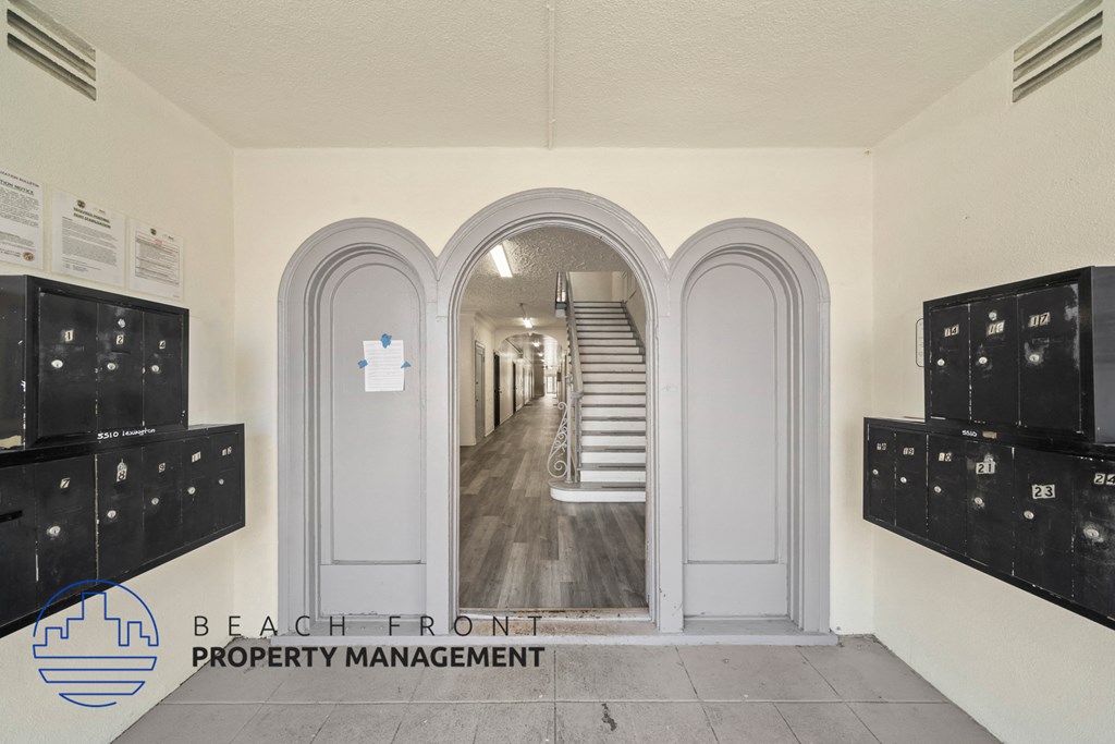 the hallway of the beachfront property management office with doors to the hallway and stairs