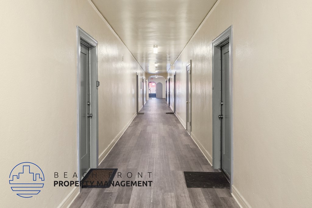 a long corridor with doors in a building