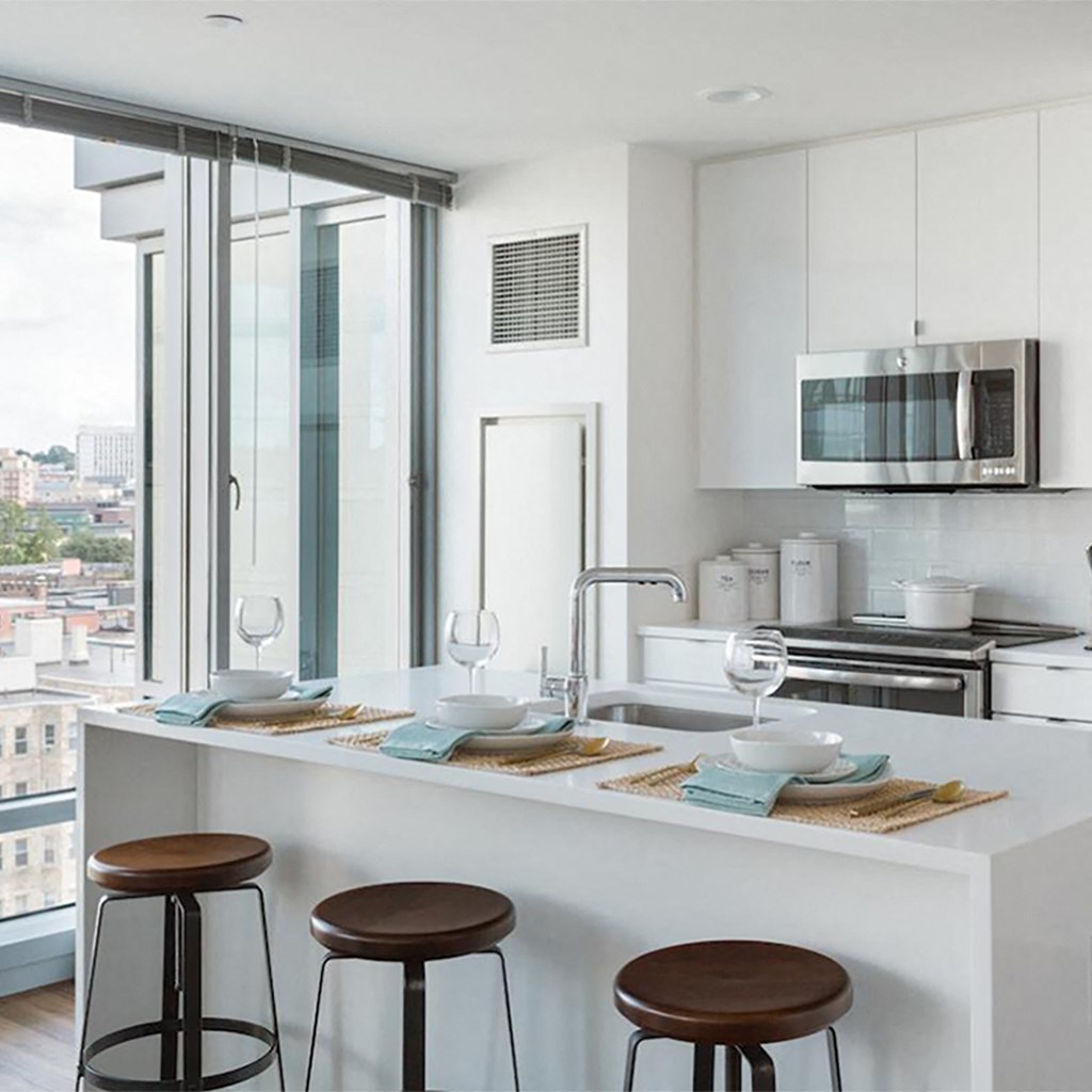 a kitchen with a counter top and some stools