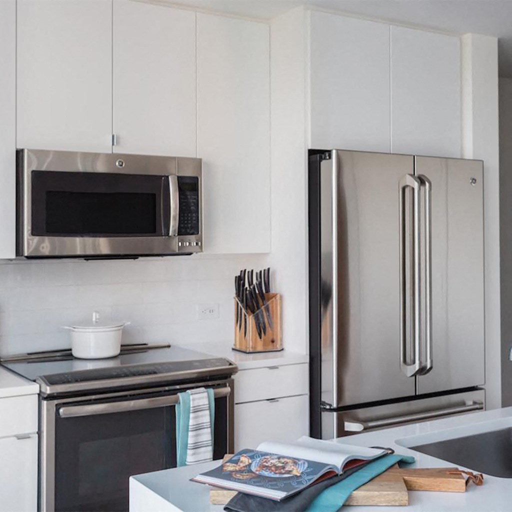 a kitchen with stainless steel appliances and white cabinets