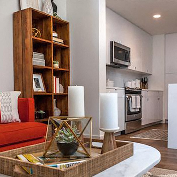 a living room with a table and a kitchen