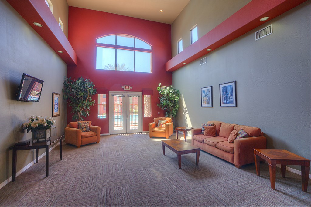 a lobby with couches and chairs and a large window