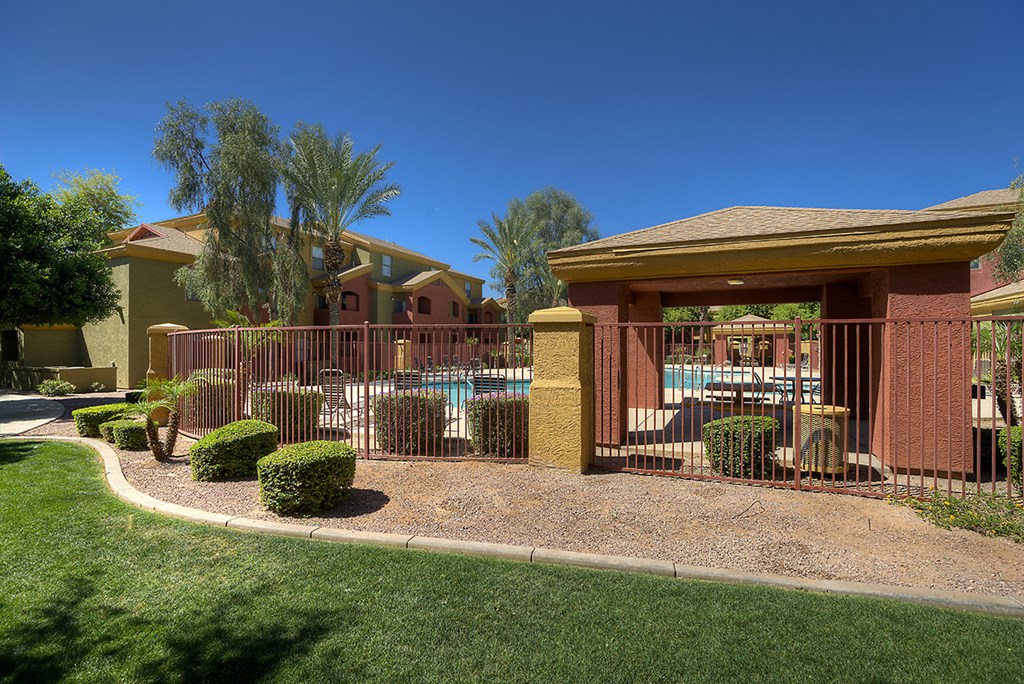 a patio with a pool in front of a house