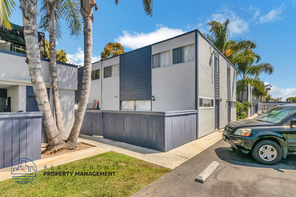 the exterior of a house with a car parked in front of it