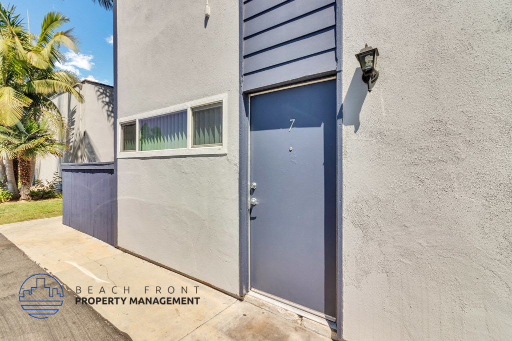 the entrance to a building with a blue door and a window