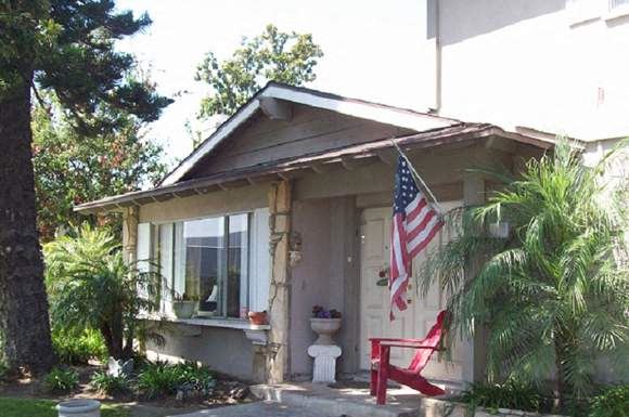 a small house with a toilet and an american flag