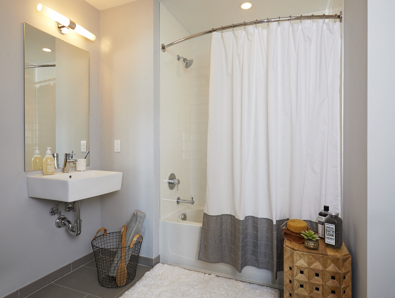 a bathroom with a shower and a sink and a shower curtain