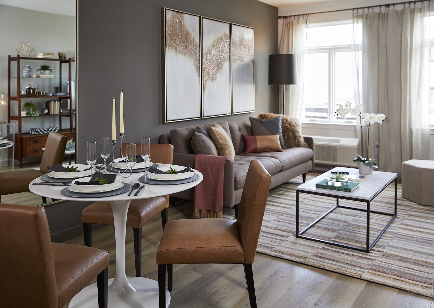 a living room with a couch and a table and chairs