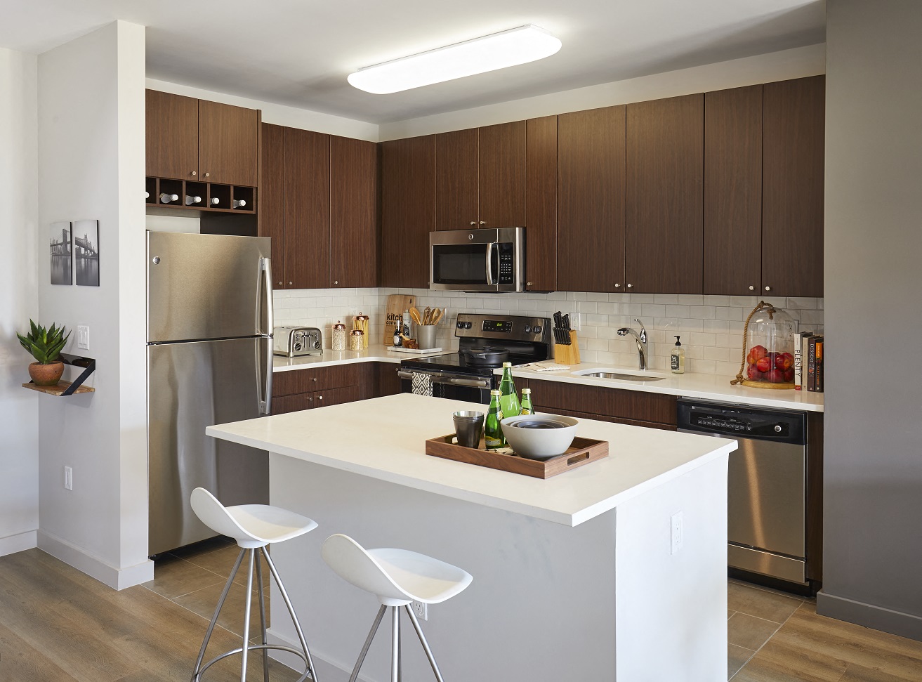a kitchen with a white island and stainless steel appliances