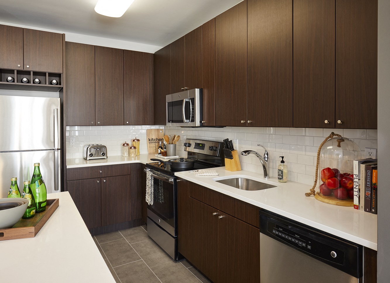 a kitchen with stainless steel appliances and wooden cabinets