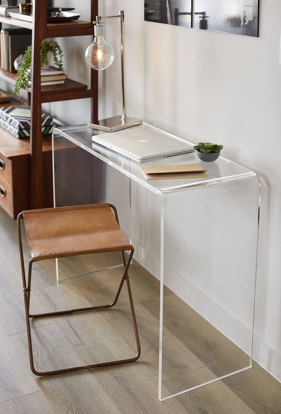 a desk with a chair and a lamp on top of it