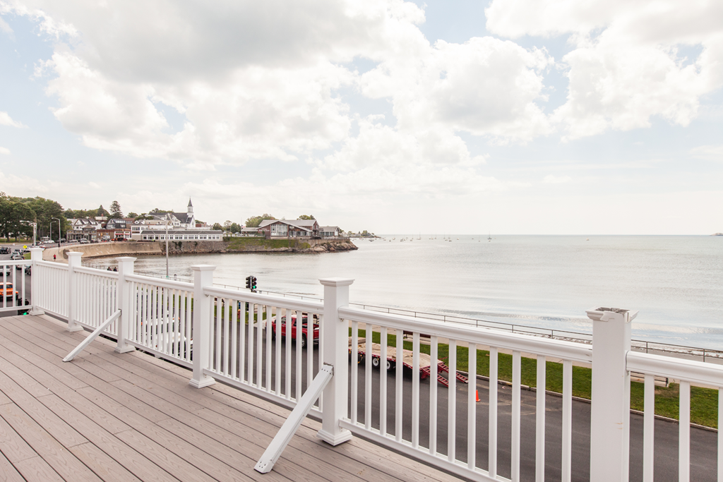 a view of the ocean from a deck with a boardwalk