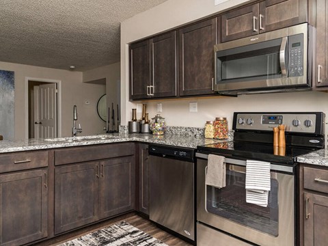 a kitchen with stainless steel appliances and wooden cabinets