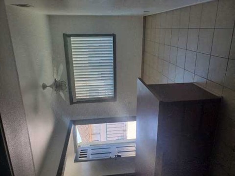 a bathroom with a window and a ceiling fan