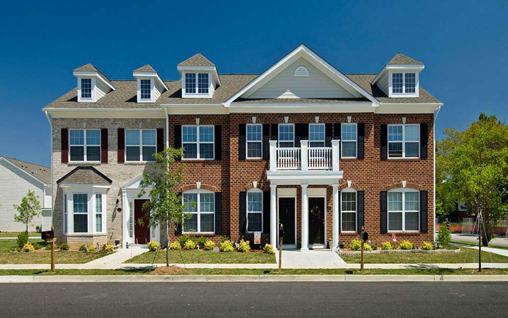 a large brick house with a street in front of it