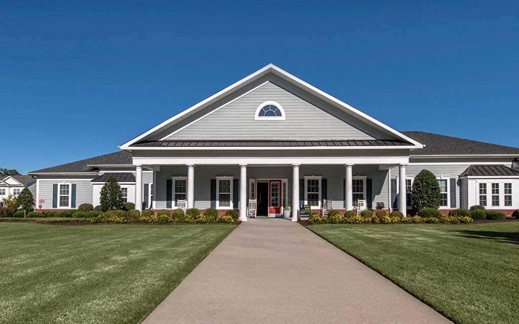 a large white house with a walkway in front of it