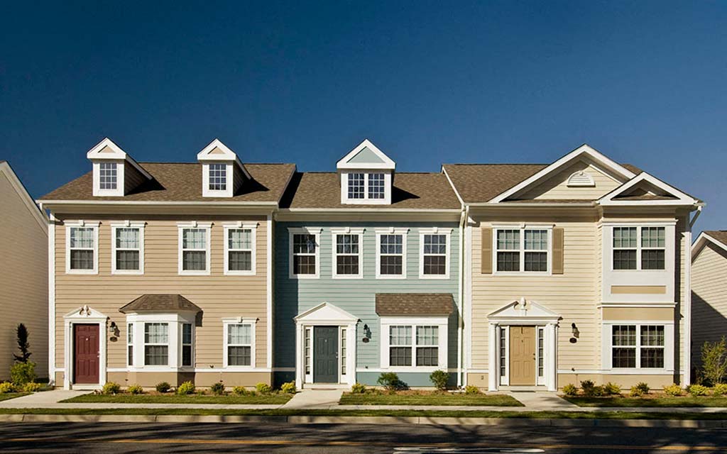 a row of town houses on the side of a street