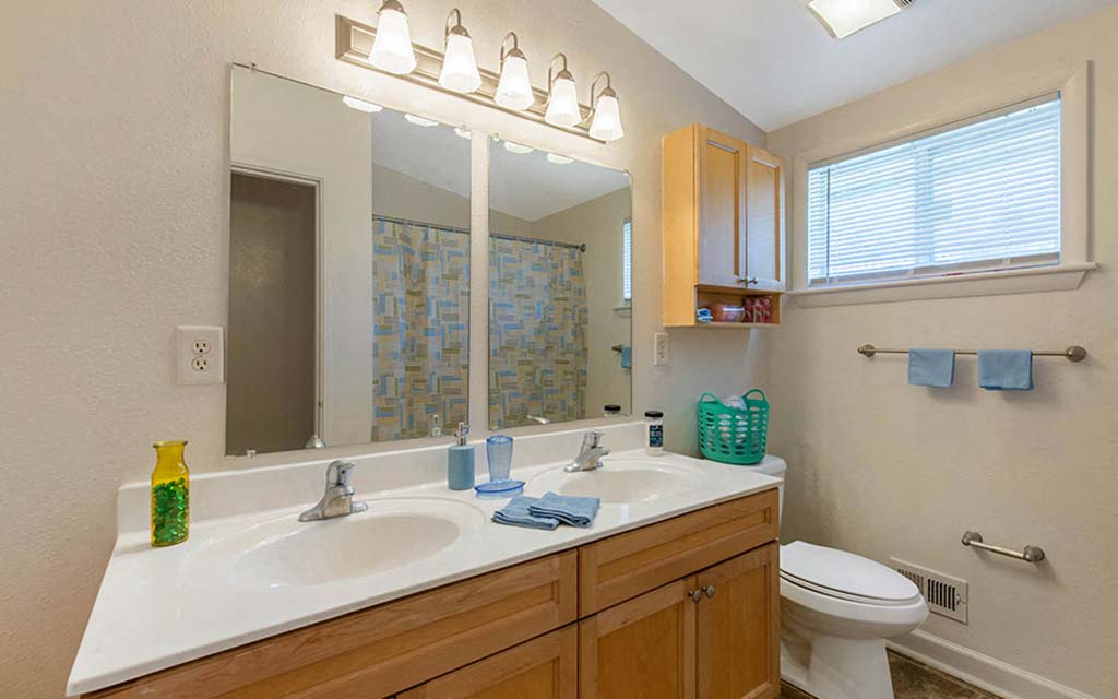 a bathroom with a sink toilet and a mirror