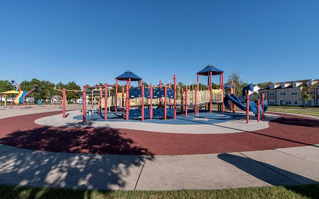 a playground with a bunch of kids playing on it