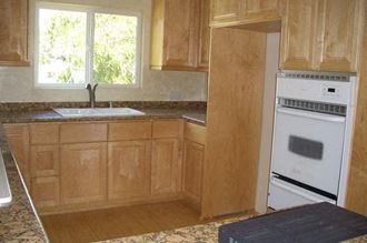 a kitchen with a stove a sink and a window