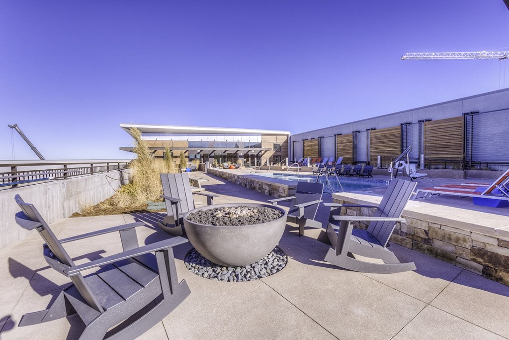 a view of a patio with chairs and a fire pit
