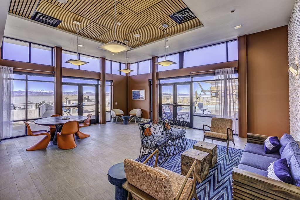 the lobby of a hotel with a view of the water