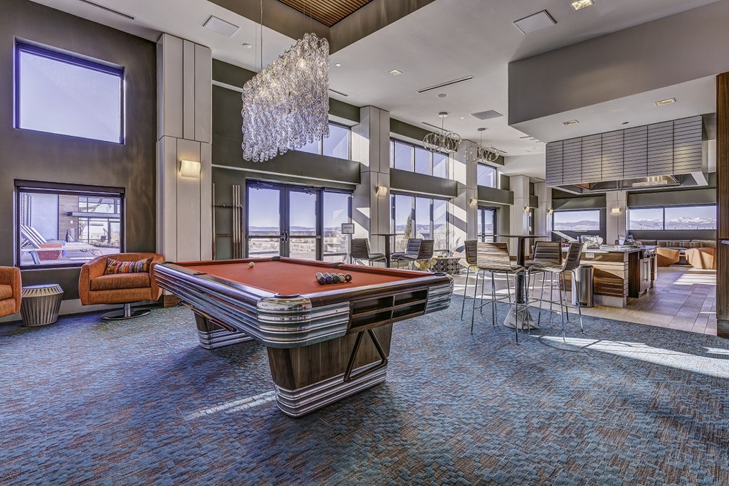 a clubhouse with a pool table in the center of it