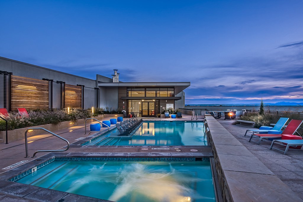 a swimming pool on the rooftop of a building at night