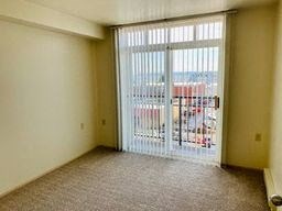 an empty living room with a sliding glass door