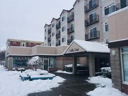 an apartment building with snow on the ground