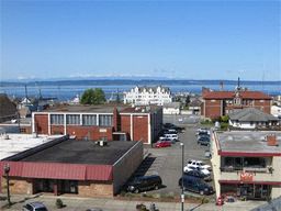 an aerial view of a city with the ocean in the background