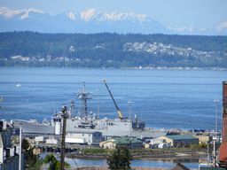 a large ship is in the water near a city