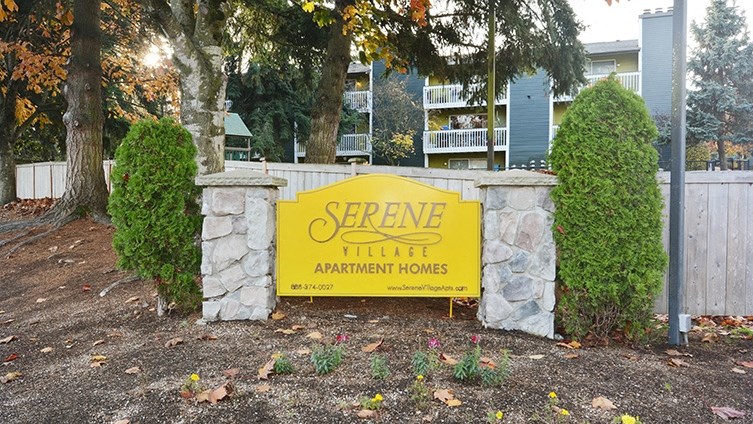 a yellow sign sitting in front of a fence