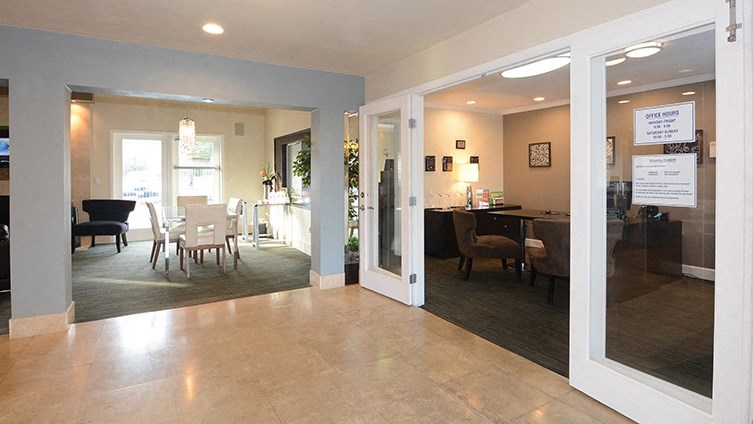a view of a living room and dining room with a table and chairs