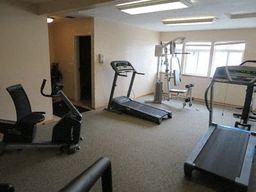 a gym with some exercise equipment in a room